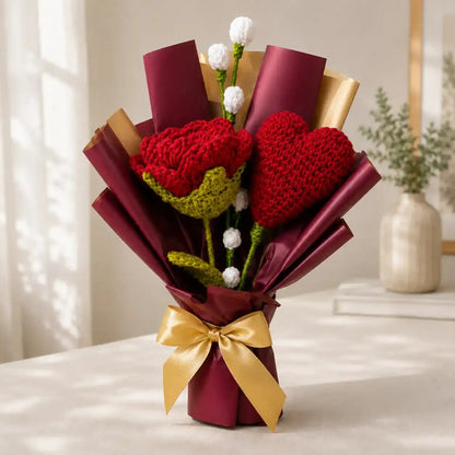 Handmade crochet heart bouquet with red yarn hearts wrapped in burgundy and gold paper tied with a satin gold ribbon